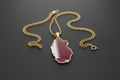 Qatar-shaped pendant with flag colors on a gold chain