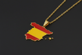 Spain-shaped pendant with flag colors on a gold chain